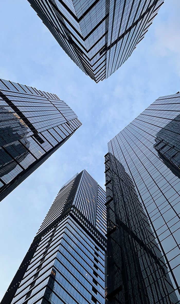 O nas Towering skyscrapers in Jakarta's central business district against a clear blue sky.